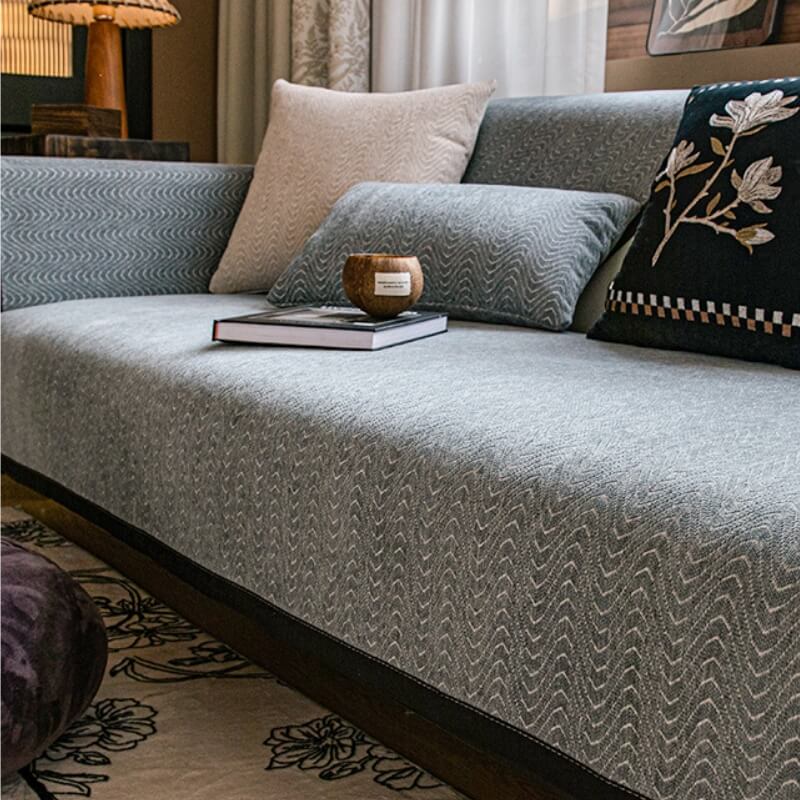 Pet-friendly chenille sofa cover draped over a modern grey couch, offering complete protection