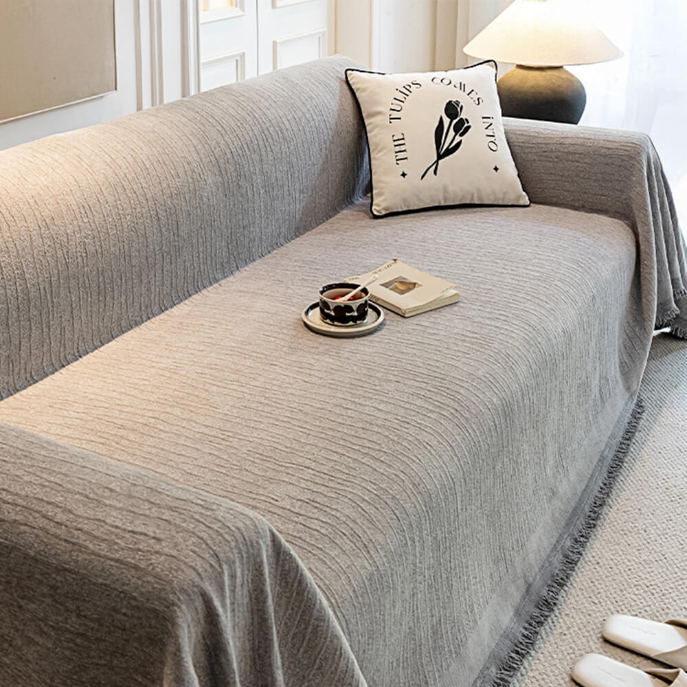 Lifestyle image of a pet relaxing on a chenille textured anti-scratch pet-friendly couch cover.