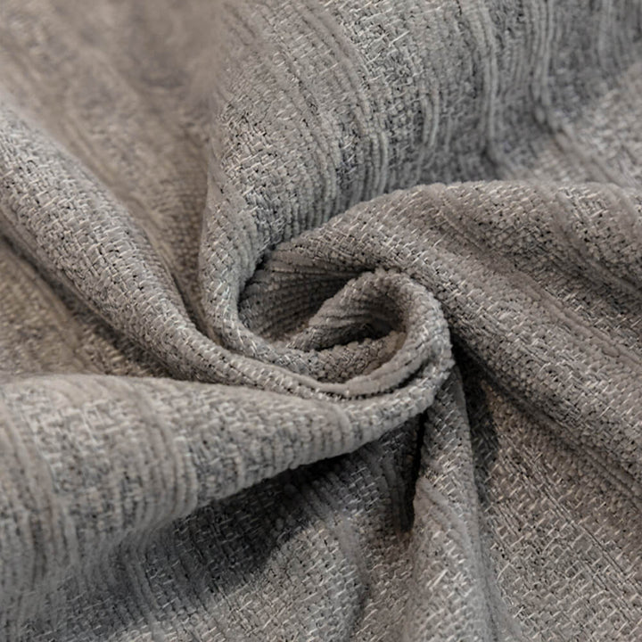 Pet-friendly anti-scratch chenille couch cover draped over a sofa, protecting furniture.
