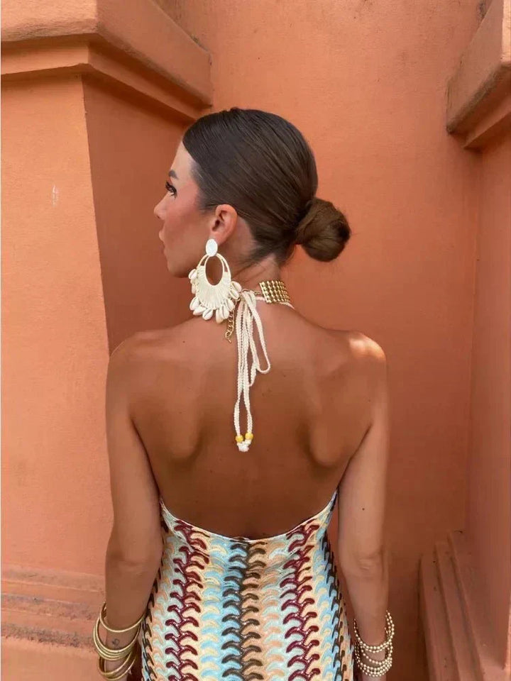 Women's elegant halter neck boho maxi dress with unique print, open back, perfect party or wedding guest wear.