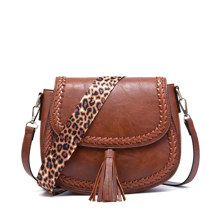 Fashion accessory: white women's saddle bag, an elegant crossbody with tassel detail.