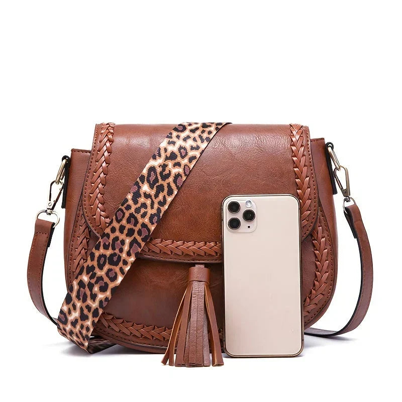 Everyday brown saddle bag for women, a chic shoulder bag with tassel & adjustable strap.