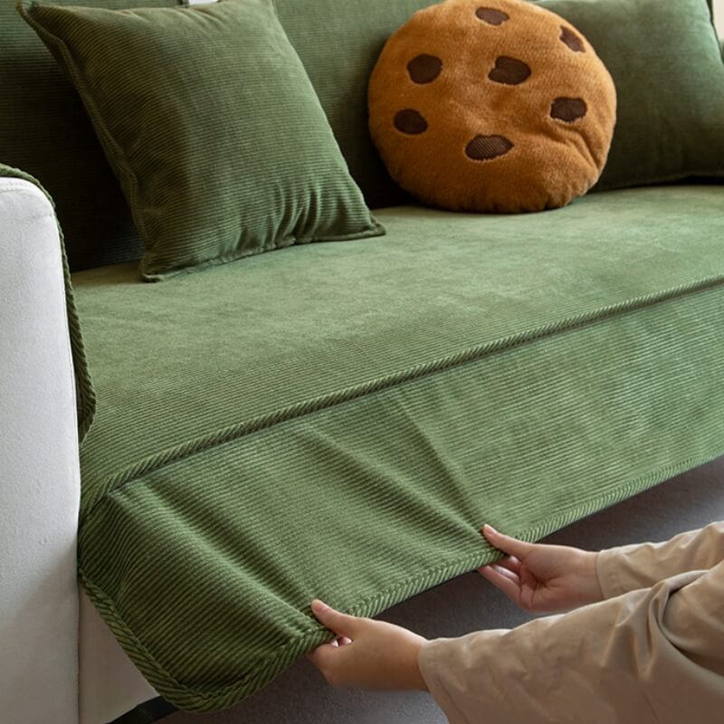 Corduroy sofa protector draped over a white couch, showcasing how it blends with home decor