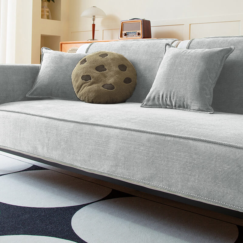 Corner view of a corduroy sectional cover, designed for anti-slip performance and cozy home decor