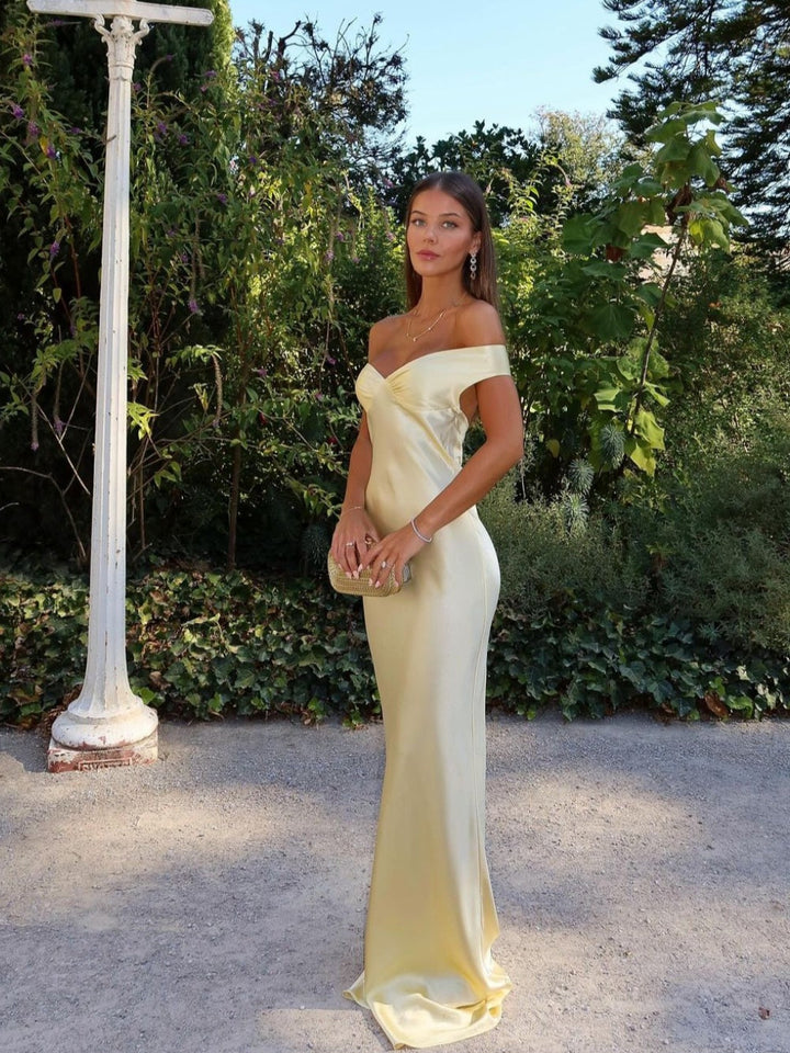 Chic gold off-shoulder maxi wedding guest dress with sweetheart neckline for elegant special occasions & garden parties.