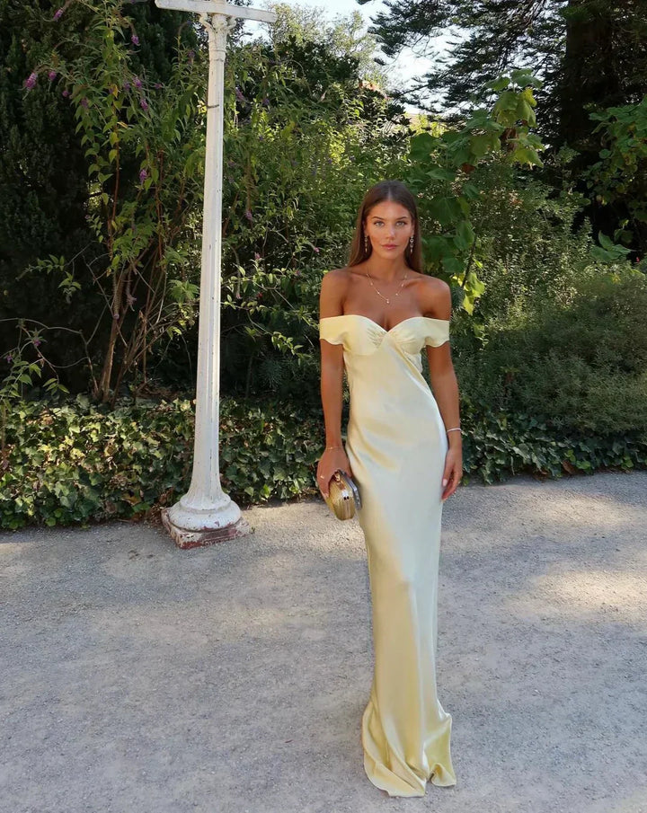 Elegant gold off-shoulder maxi dress, perfect as a formal wedding guest gown or evening dress. Sweetheart neckline.