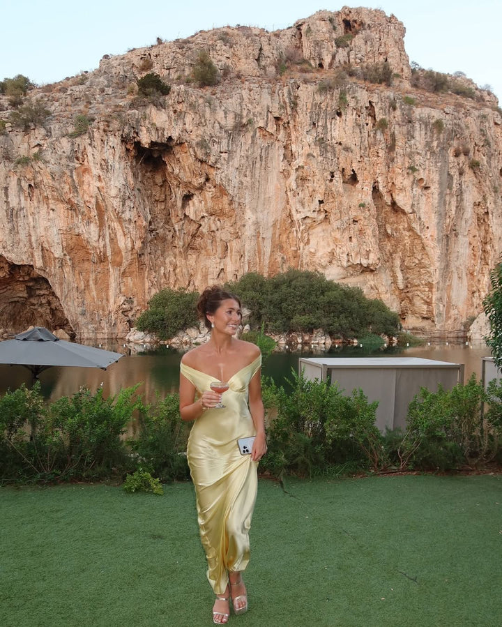 Stunning gold off-shoulder maxi dress, an elegant choice for women attending weddings, formal events, or garden parties.
