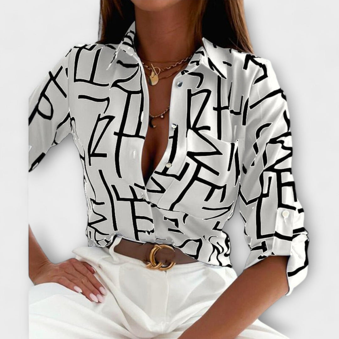 Full length shot of women's abstract print button-down blouse, flowy fabric, chic style.