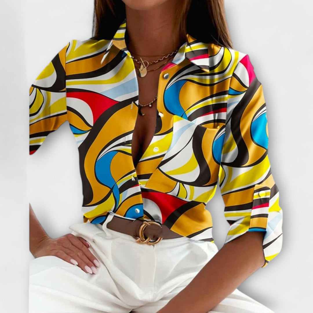 Side view of a women's abstract print button-down blouse, highlighting its relaxed drape.