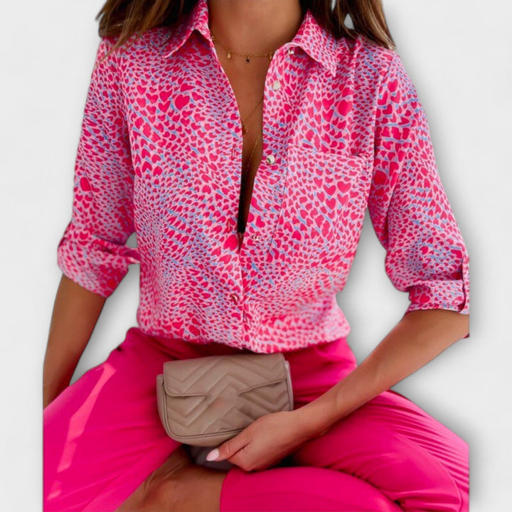 Women's patterned long sleeve blouse featuring a vibrant abstract design. Button-down front.