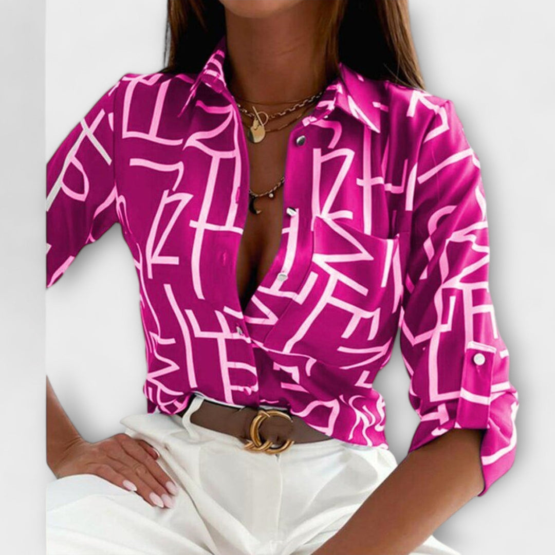 Detail of buttons and collar on a chic women's abstract print button-down blouse.