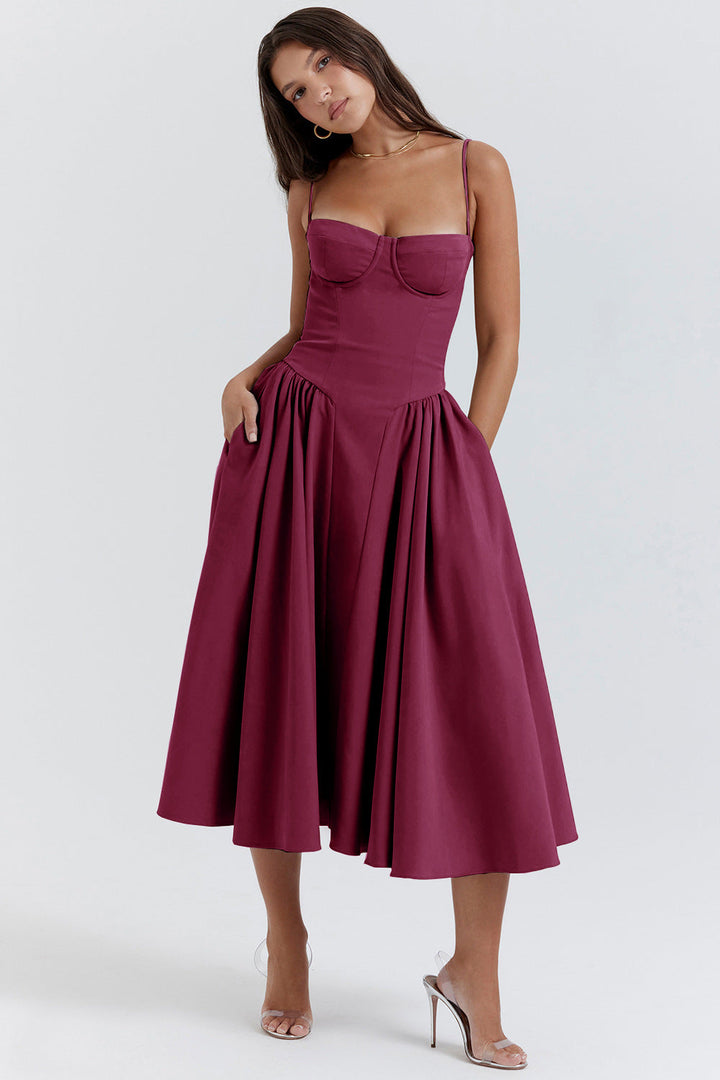 Sophisticated women's midi A-line dress with structured corset & delicate spaghetti straps for wedding guests.