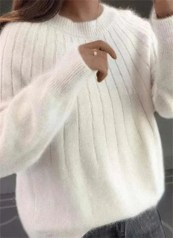 Close-up of a women's cozy textured knit sweater, highlighting its soft, chic, and comfortable design.