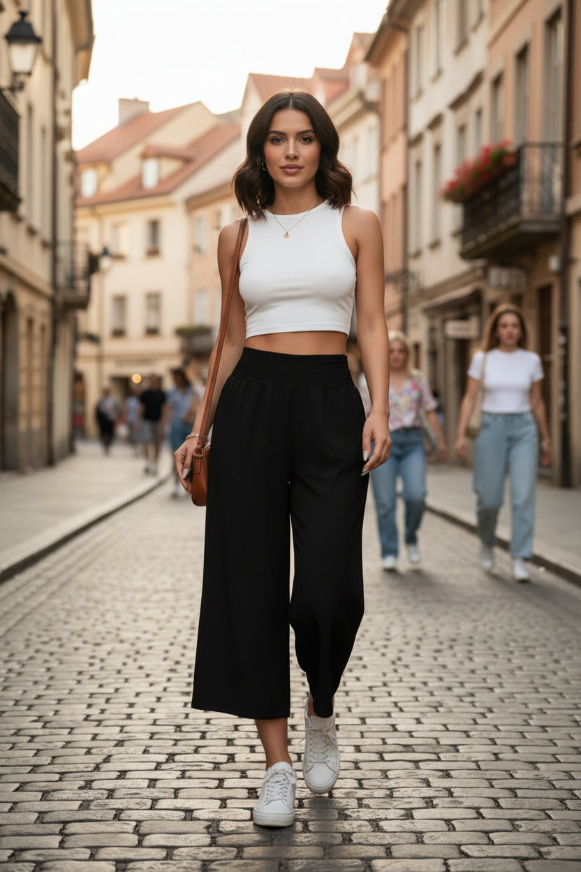 Flowy cropped wide-leg pants for women, featuring a comfortable elastic waist. Ideal chic summer trousers.