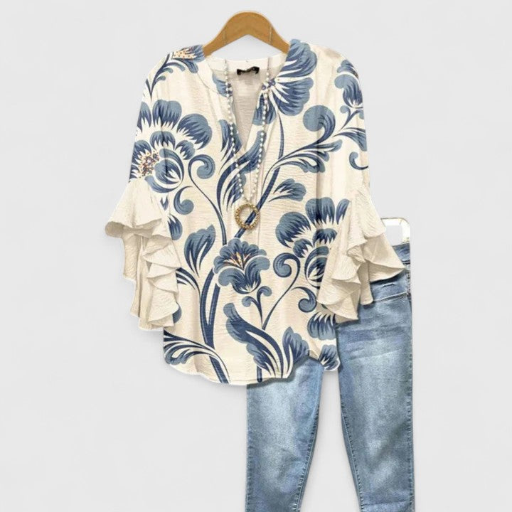 Chic women's floral blouse with vibrant print & ruffled sleeves, perfect for summer fashion & elegant occasions.