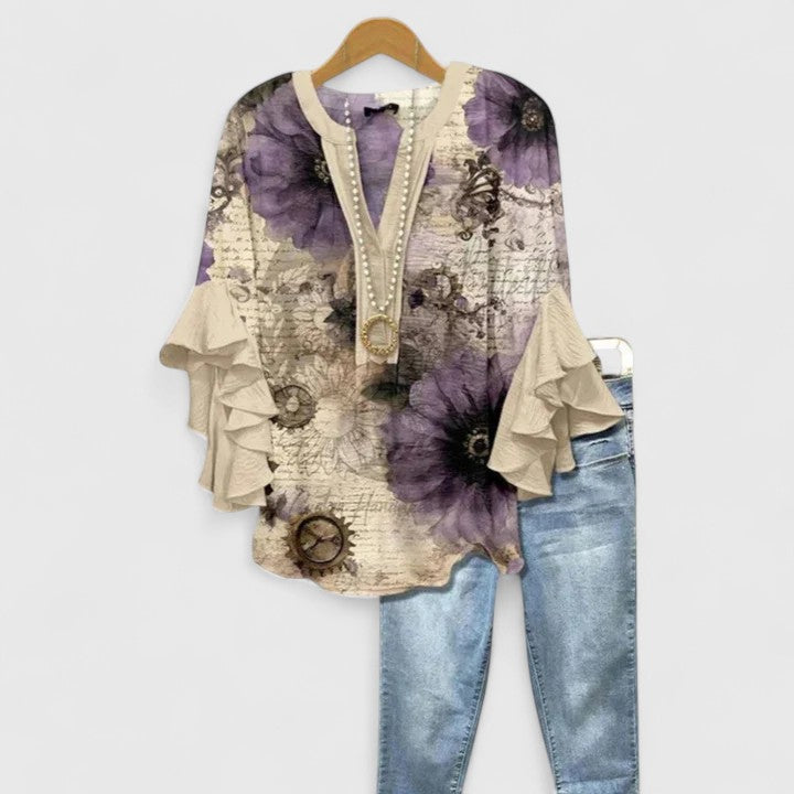 Flowy women's floral blouse with ruffled sleeves. A chic & versatile top, great for elegant summer fashion.