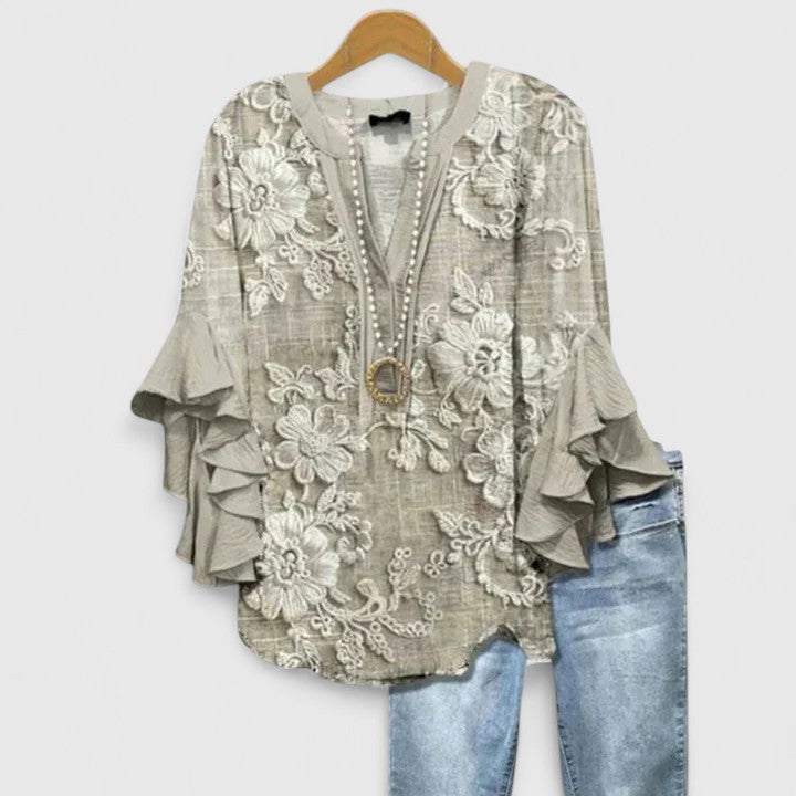 Elegant women's floral top, versatile for casual wear or dressy occasions. Features a vibrant print & chic style.