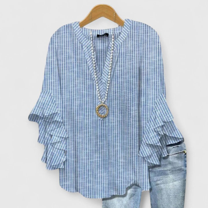 Women's chic floral blouse featuring vibrant print & stylish ruffled sleeves. A versatile top for any summer occasion.