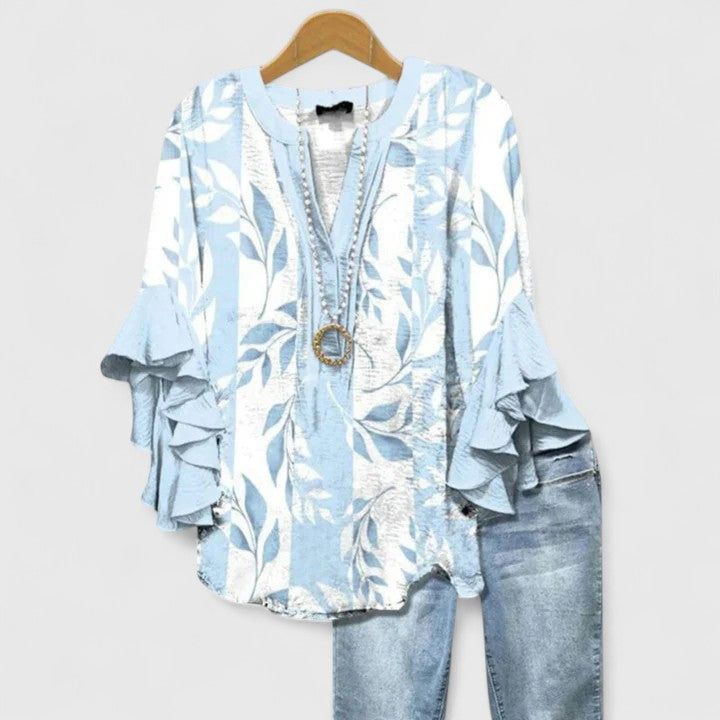 Modern women's elegant floral blouse with subtle ruffled sleeves. A chic top for versatile fashion styling.