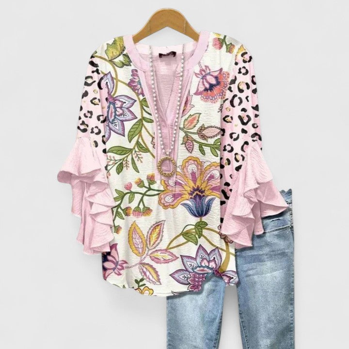 Light & airy women's floral blouse with a vibrant pattern & chic style. Ideal for comfortable summer wear.
