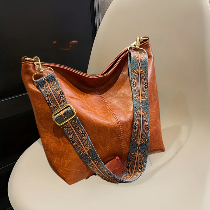 Women's geometric print shoulder bag with adjustable strap. Spacious, chic handbag for versatile everyday use.