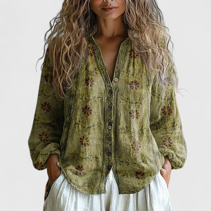 Elegant women's long sleeve blouse in a fashionable leaf print, offering a chic and comfortable style.