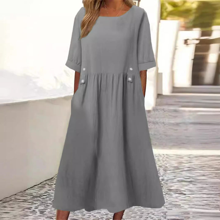 Versatile women's midi dress, comfortable loose fit and round neck, ideal for casual day or elegant summer holidays.