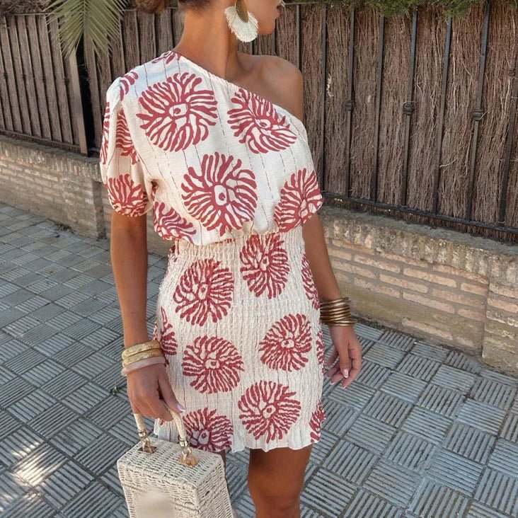 Chic women's printed one-shoulder mini dress, perfect for a wedding guest or summer party. Elegant and fashionable.