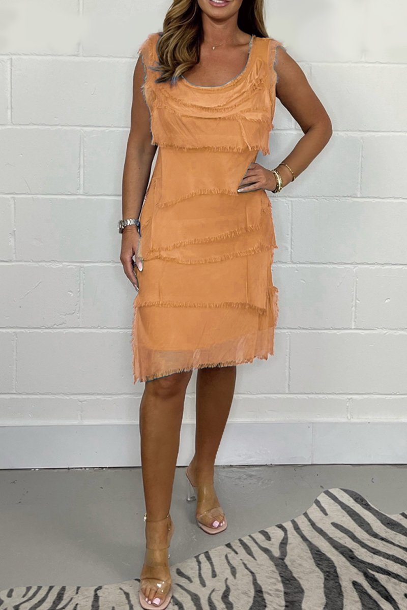 Woman wearing a chic sleeveless layered dress casually, versatile for spring and summer days.