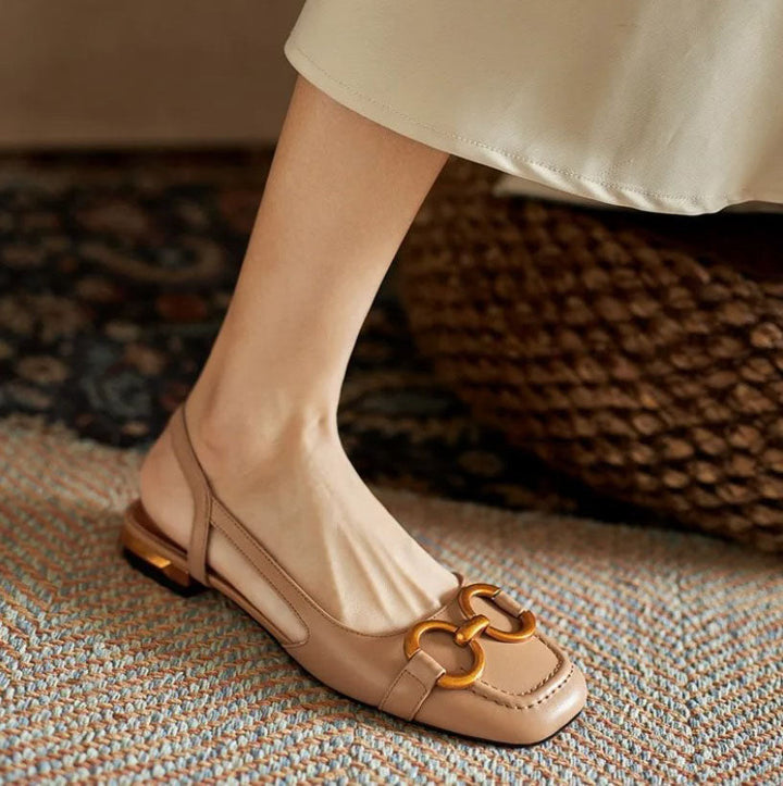 Close-up of women's chic slingback flats, showcasing ergonomic footbed, elegant gold detail, and comfortable design.