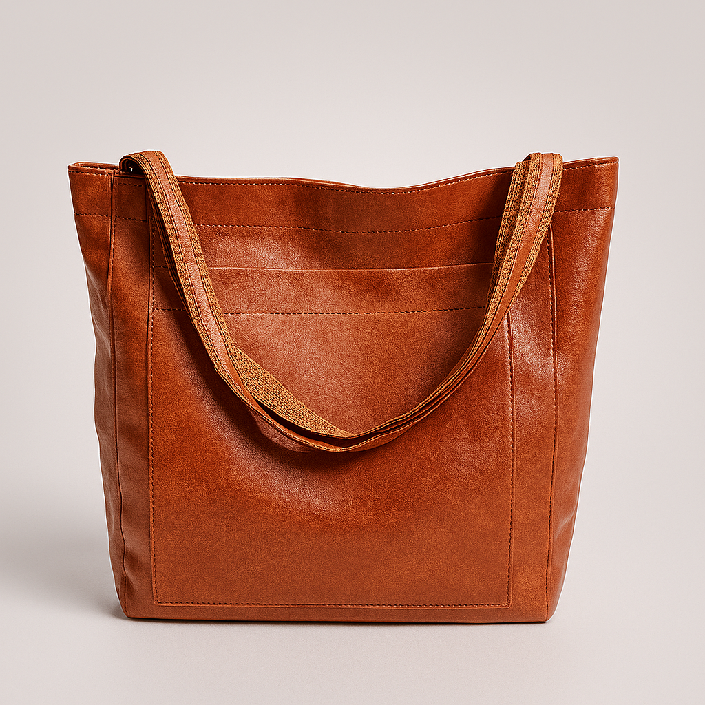 Chic women's structured tote bag with an exterior front pocket, perfect as a versatile shoulder or work handbag.