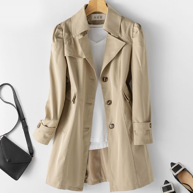 Stylish black tailored trench coat for women, versatile outerwear, perfect for an elegant business casual look.