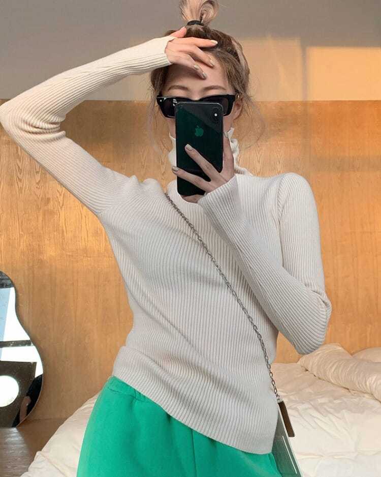 High neck women's turtleneck sweater, a chic knit pullover offering warmth & style for winter.
