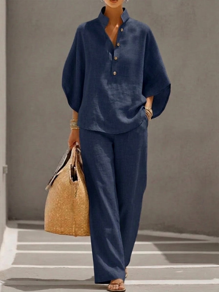 Elegant casual women's set: flowy batwing blouse and wide leg trousers. Ideal for summer fashion.