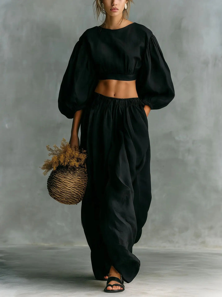 Women's two-piece outfit: cropped top with balloon sleeves & comfortable wide-leg trousers. Stylish, relaxed fit.
