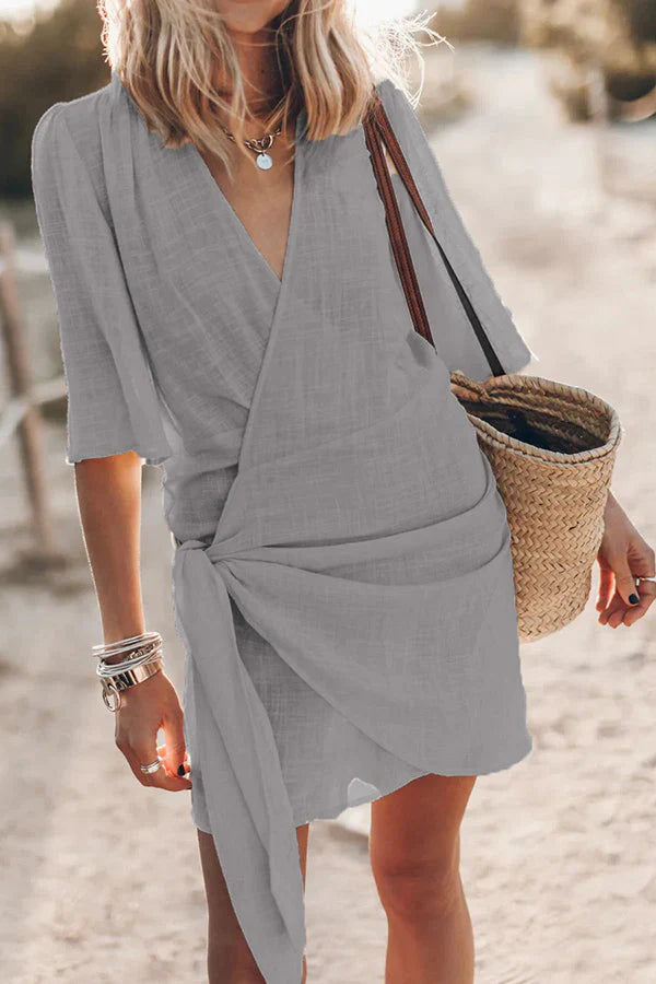Chic women's V-neck draped mini dress, perfect for summer style & vacation wear. Flattering fit.