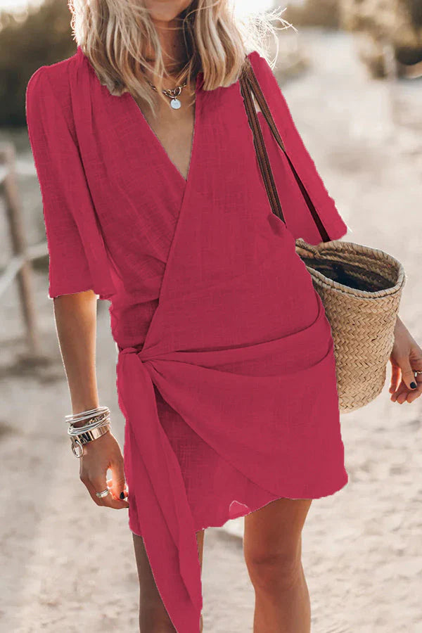 Elegant women's V-neck mini dress with flattering drape, ideal for summer parties & casual elegance.