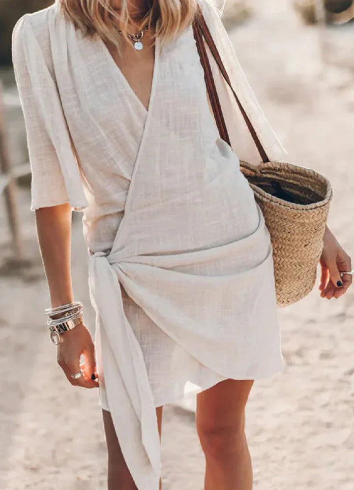 Vibrant women's mini dress, featuring a V-neck & elegant drape. Essential for chic summer style & vacation.