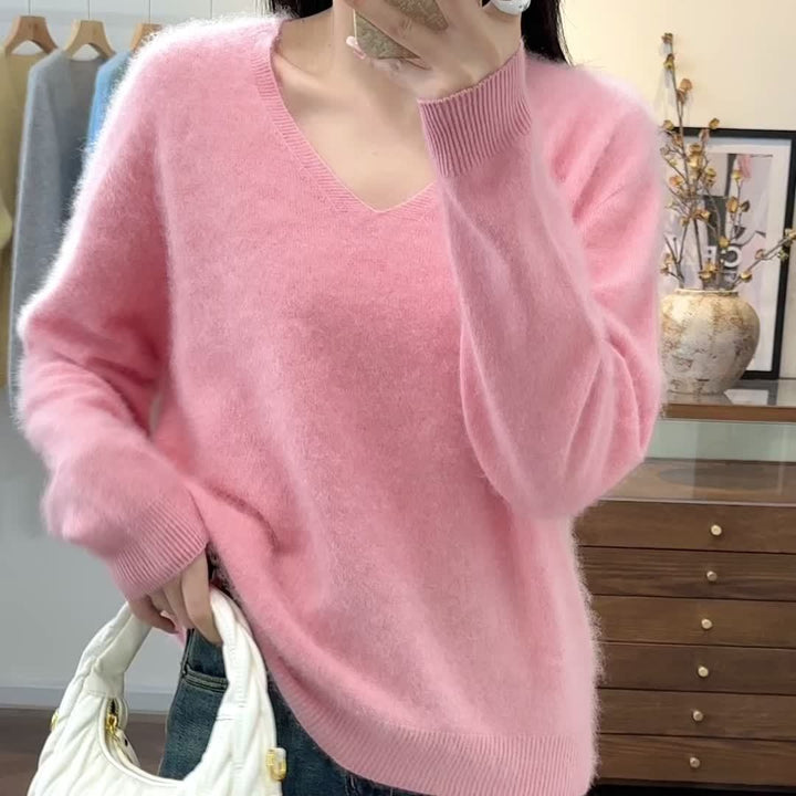 Stylish women's oversized V-neck sweater. Chic autumn fashion wardrobe staple with a comfortable, relaxed fit.