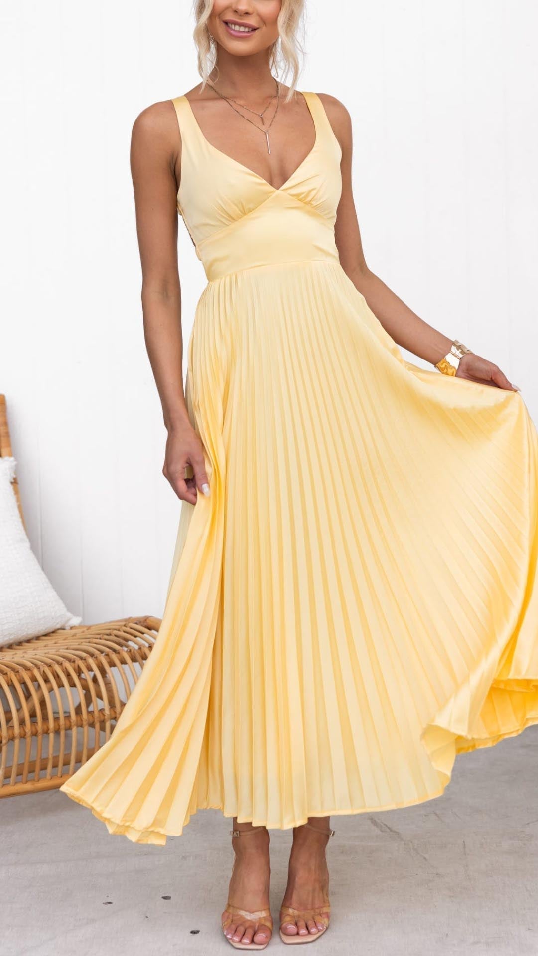 Chic yellow V-neck pleated midi wedding guest dress for women. Elegant A-line summer occasion party dress.