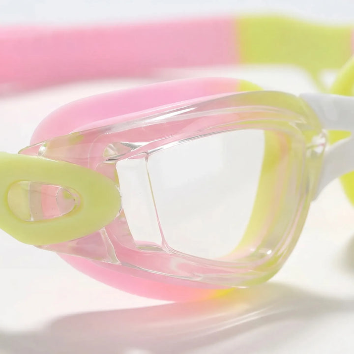 Youth clear lens swim goggles with anti-fog technology and built-in earplugs for water sports.
