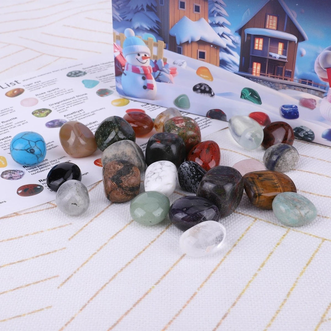 Collection of various unearthing tools, magnifying glass, and gemstones from the kids' science advent calendar kit.