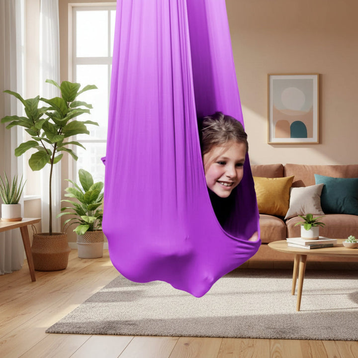 Cozy indoor therapy swing for children, enhancing focus & providing calming sensory input in playrooms.