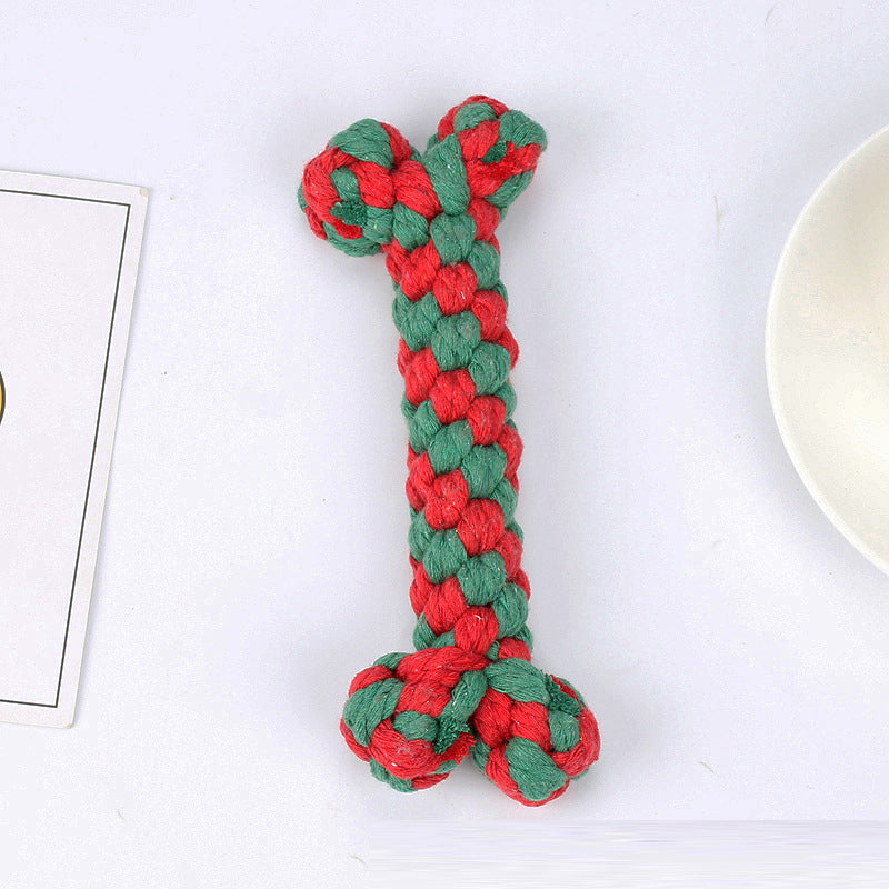 Collection of holiday dog toys, including rope, squeaky Santa, and bone, promoting dental health