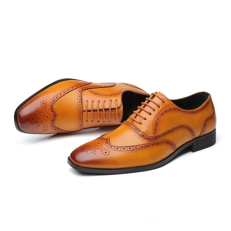 Dark brown Oxford brogue shoes for men, featuring a refined silhouette & exquisite detailing.