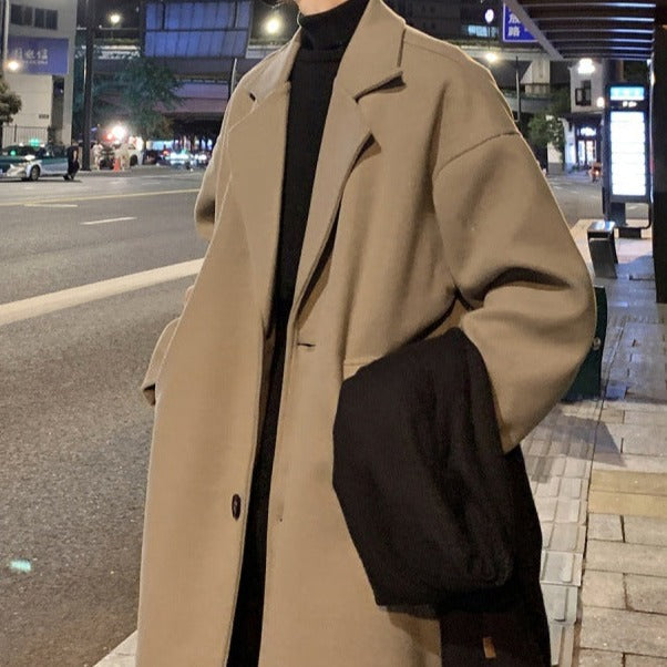 Man wearing a stylish long belted overcoat, demonstrating its smart casual fit & layered look for winter.