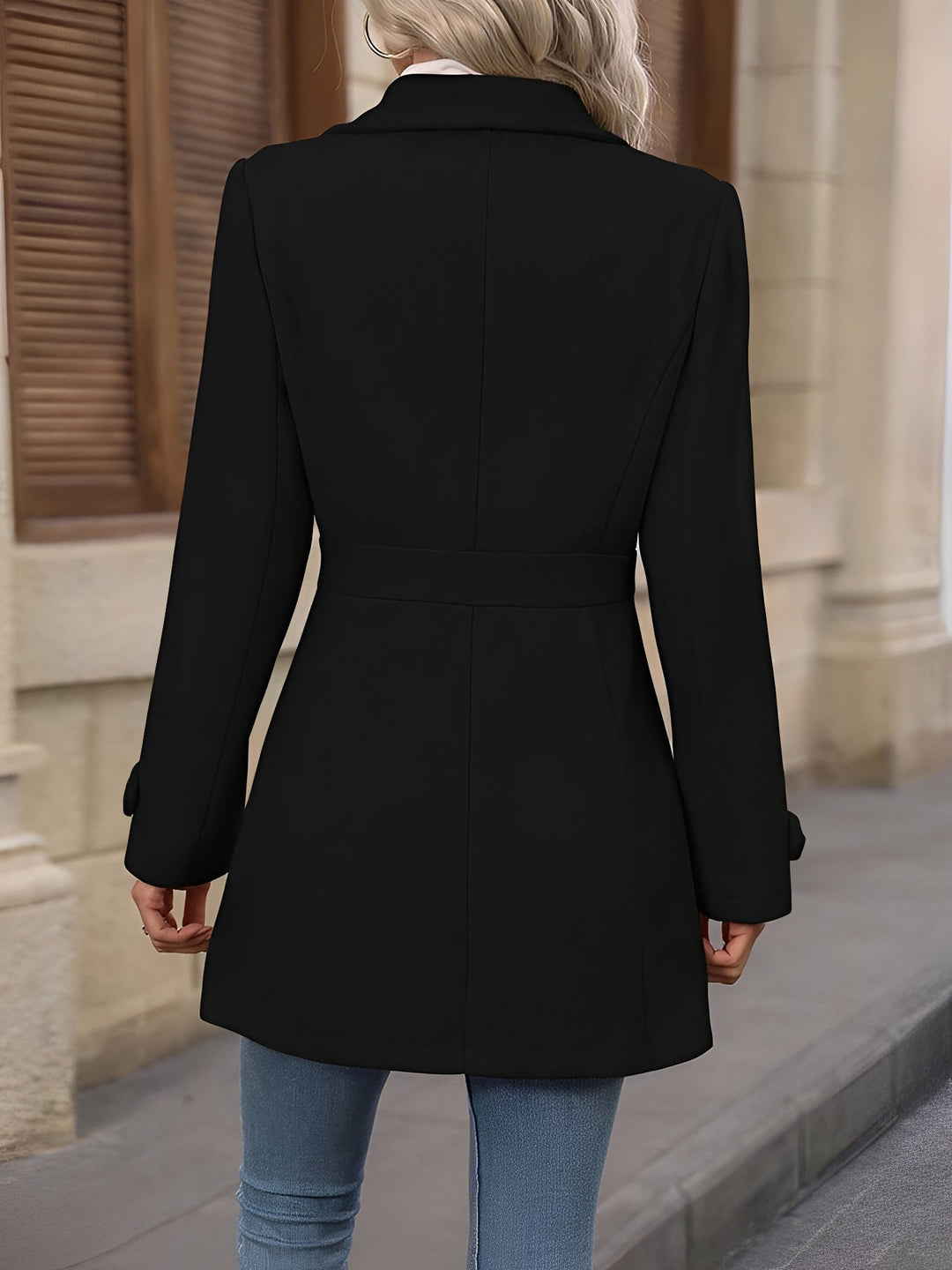 Adjustable belted waist on an elegant women's trench coat with a sophisticated notch collar.