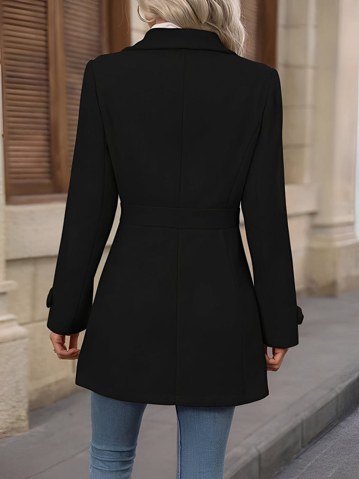 Adjustable belted waist on an elegant women's trench coat with a sophisticated notch collar.