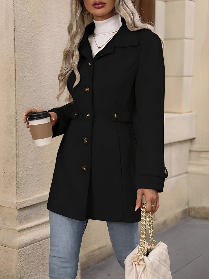 Navy blue women's double-breasted trench coat, elegant with a notch collar & belted waist.