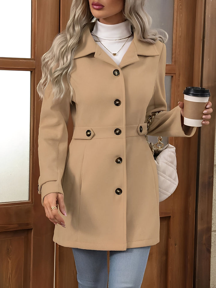 Longline trench coat for women, featuring a stylish notch collar and adjustable belt. Classic outerwear.